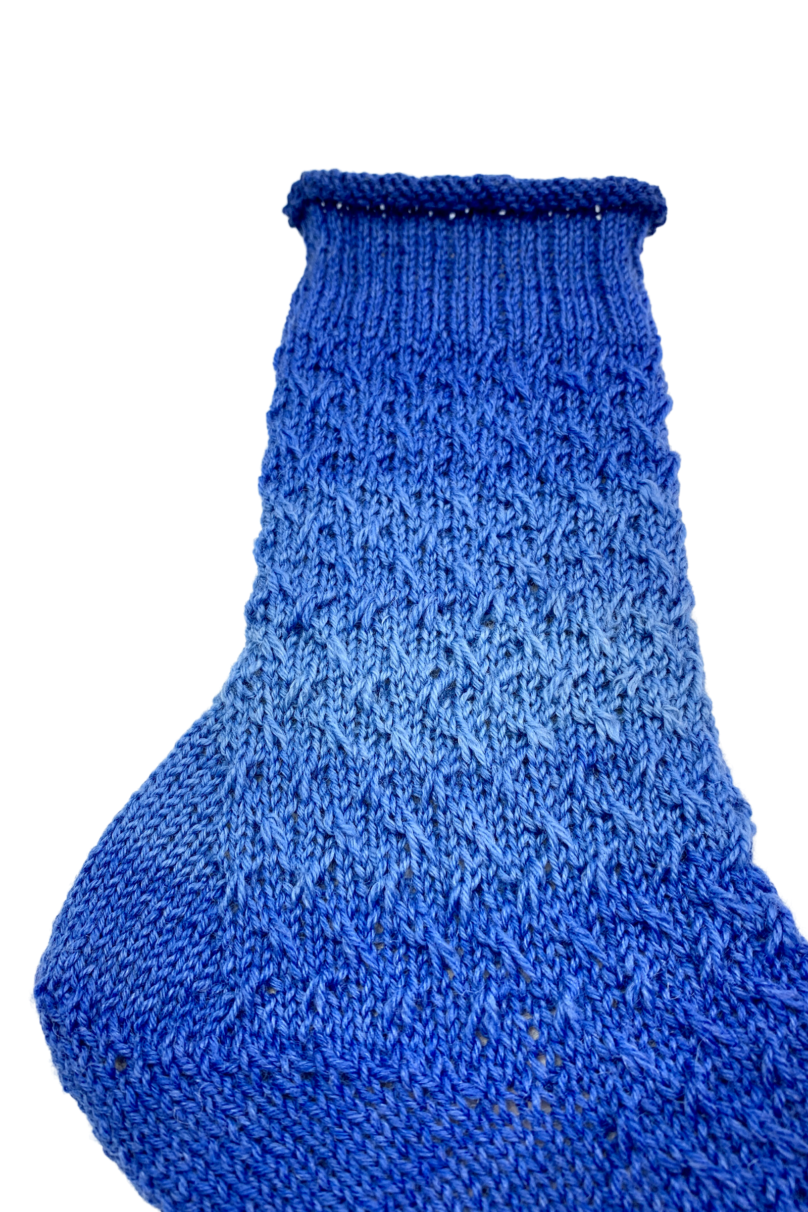 Detail view of the rolled edge, leg and slip-stitch pattern of the blue 15-Years-Socks
