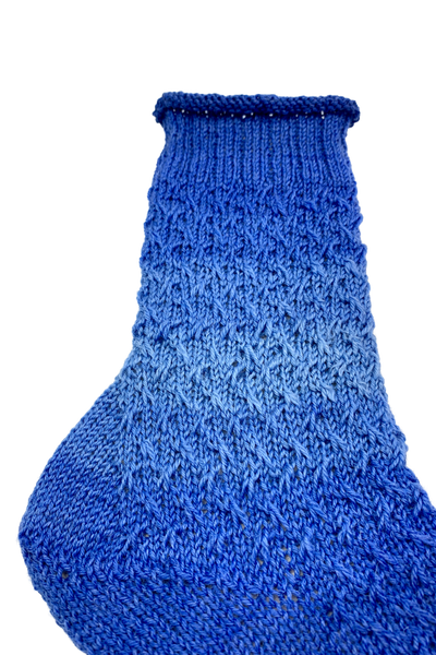 Detail view of the rolled edge, leg and slip-stitch pattern of the blue 15-Years-Socks
