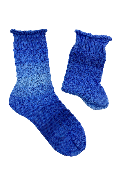 Pair of blue 15-Years-Socks with rolled edge and diagonal slip-stitch pattern